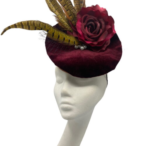 Wine/burgundy coloured percher hat with wine/burgundy flower and finished in fab feather detail.